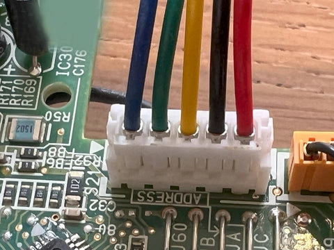 Close-up of a circuit board with colored wires and connectors.