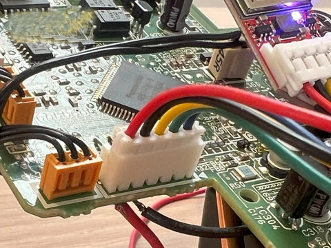 Close-up of electronic components on a circuit board with wires and connectors.