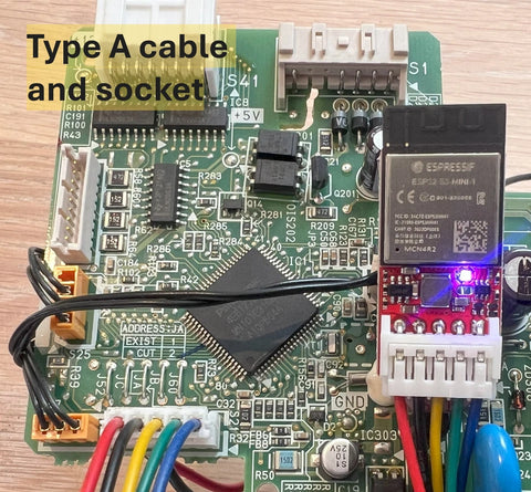 Electronic circuit board with Type A cable and socket on a wooden surface.