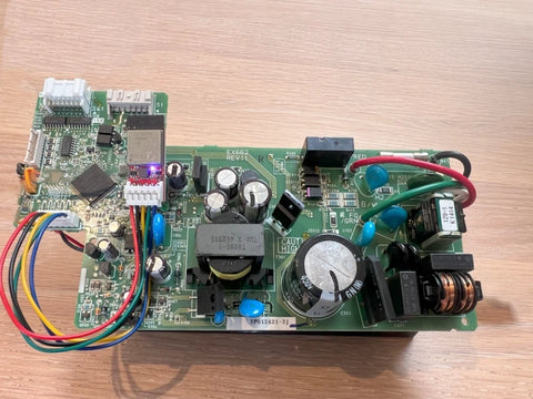 Electronic circuit board with various components on a wooden surface